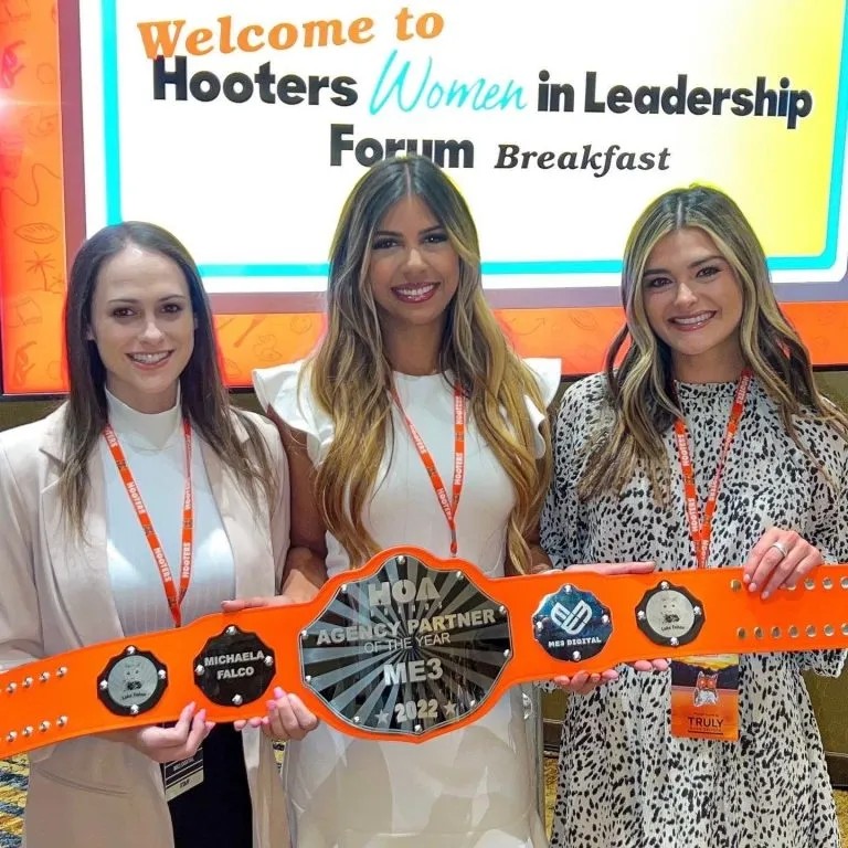 Michaela Falco and the ME3 Digital team with the 2022 Hooters Agency Partner of the Year award